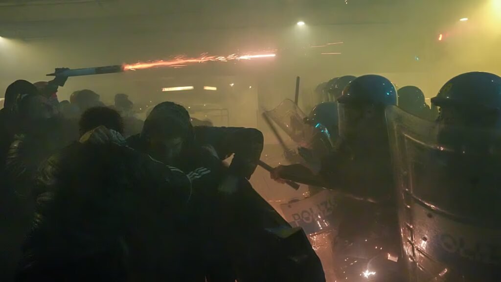 Italian law enforcement deploys tear gas amid clashes with protesters near Winter Olympics site.