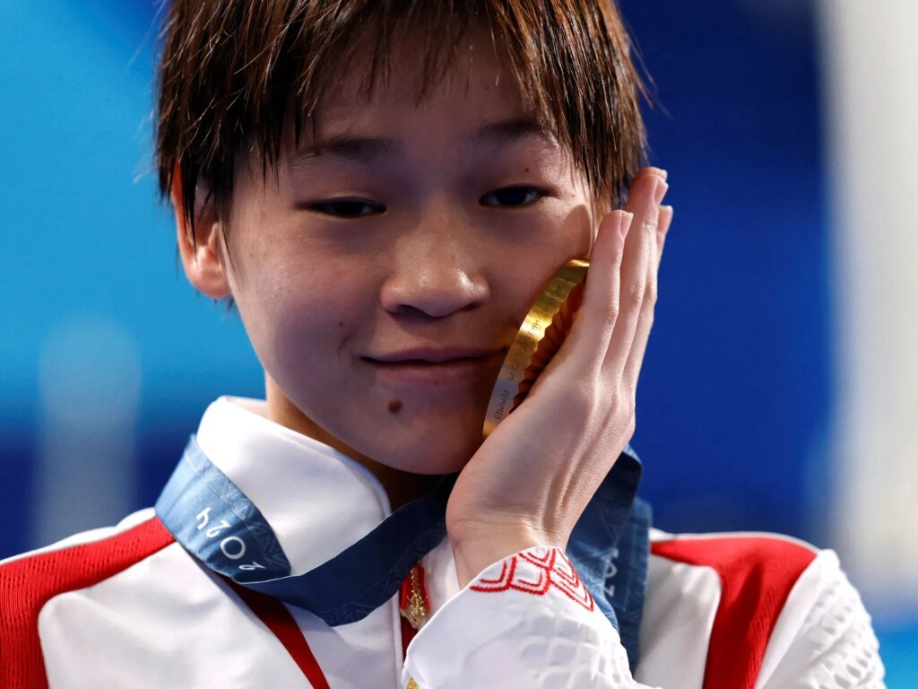 China investigates 'malicious' online harassment of teenage diving champion Quan.